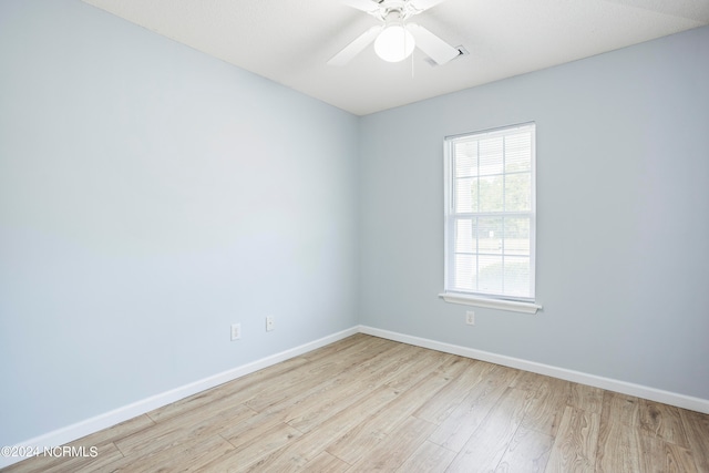 spare room featuring light hardwood / wood-style floors and ceiling fan