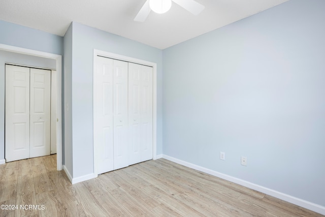 unfurnished bedroom featuring light hardwood / wood-style flooring, a closet, and ceiling fan