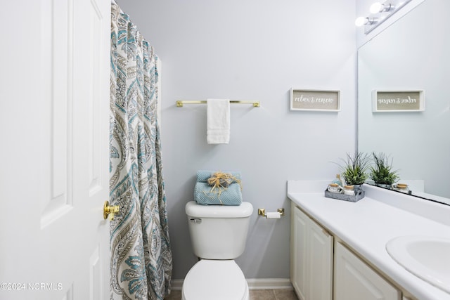 bathroom with vanity, toilet, and tile patterned floors