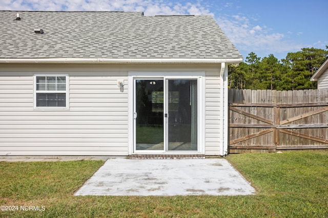 back of house featuring a patio area and a lawn