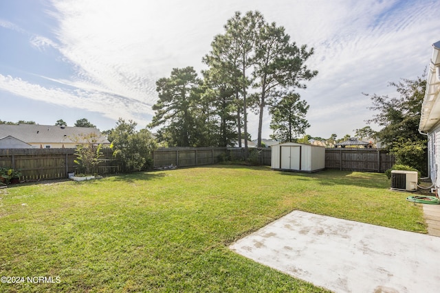 view of yard featuring a patio, a storage shed, and central AC unit