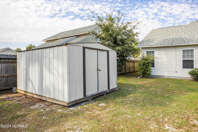 view of outbuilding featuring a lawn