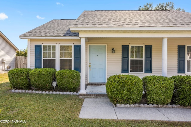 bungalow featuring a porch and a front lawn