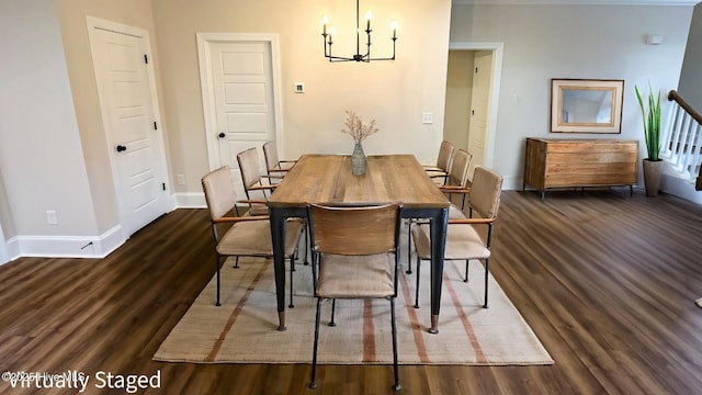 dining space featuring a chandelier, dark wood finished floors, and baseboards