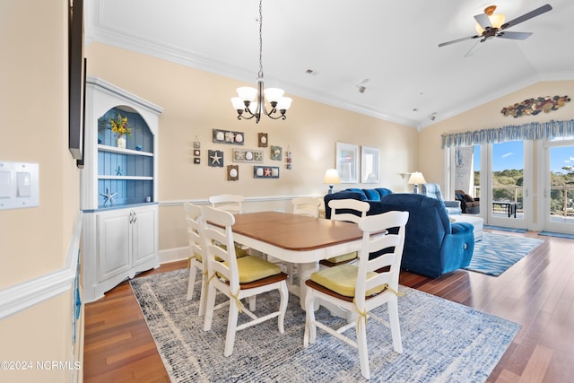 dining room featuring ceiling fan with notable chandelier, lofted ceiling, crown molding, and dark wood-type flooring