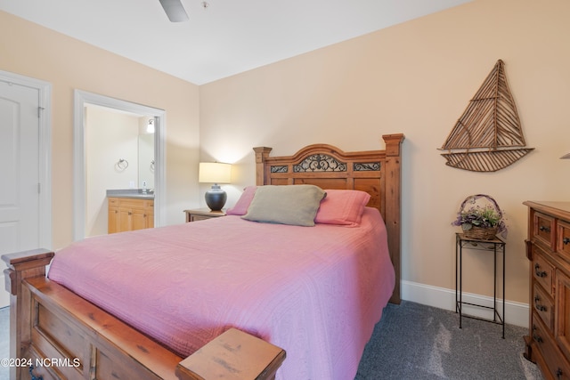 carpeted bedroom with ceiling fan and ensuite bath