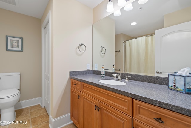 bathroom featuring tile patterned flooring, vanity, and toilet