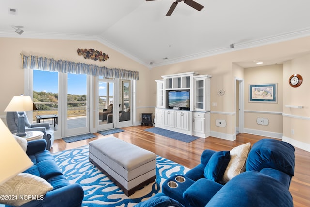 living room featuring crown molding, vaulted ceiling, and light hardwood / wood-style floors