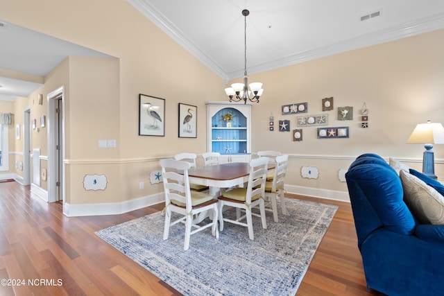 dining room featuring an inviting chandelier, crown molding, and dark hardwood / wood-style flooring