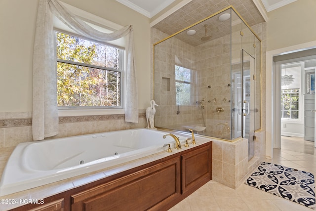 bathroom featuring a wealth of natural light, ornamental molding, and shower with separate bathtub