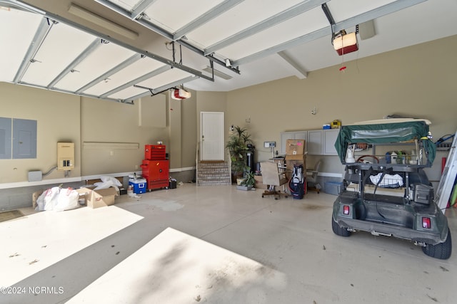 garage with a garage door opener and electric panel