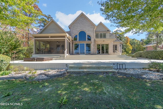 rear view of house featuring a patio, ceiling fan, a yard, and a balcony