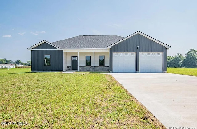 modern farmhouse style home with a garage, a porch, and a front yard