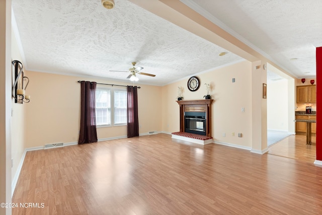 unfurnished living room with light hardwood / wood-style flooring, a textured ceiling, crown molding, and ceiling fan