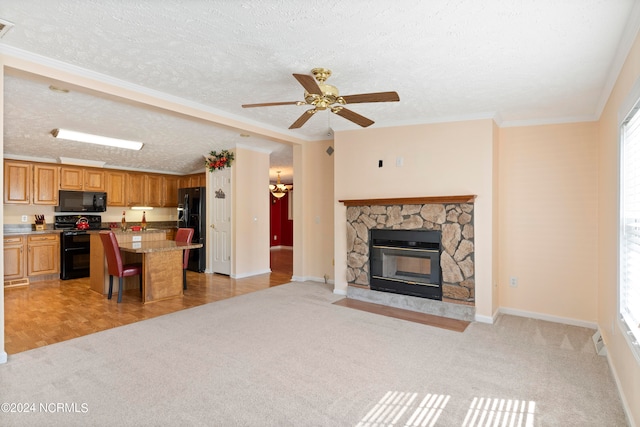 unfurnished living room with ceiling fan, a textured ceiling, a fireplace, crown molding, and light parquet floors