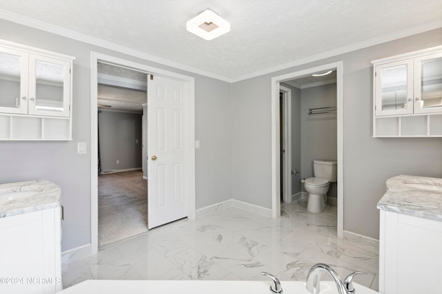 bathroom featuring vanity, crown molding, a textured ceiling, and toilet