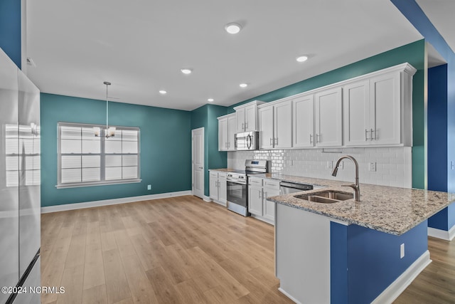 kitchen with stainless steel appliances, light hardwood / wood-style flooring, white cabinets, and sink