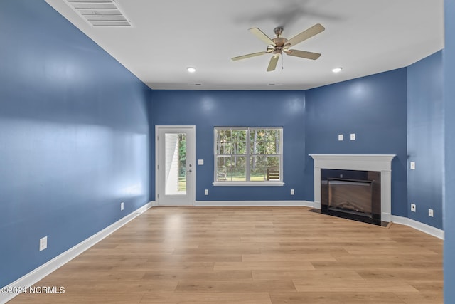 unfurnished living room featuring ceiling fan and light hardwood / wood-style flooring