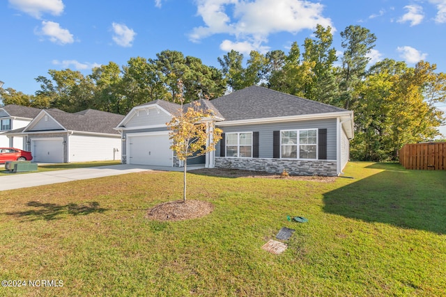 ranch-style house featuring a garage and a front lawn