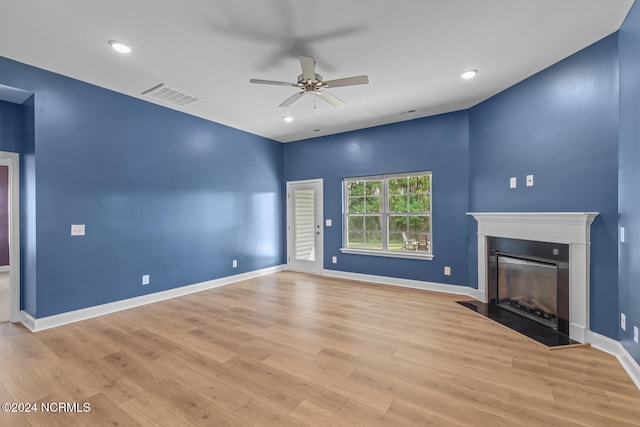 unfurnished living room featuring ceiling fan and light hardwood / wood-style flooring