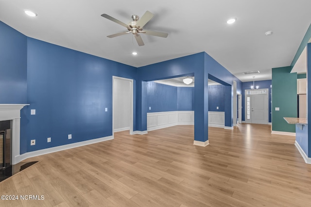 unfurnished living room featuring ceiling fan and light hardwood / wood-style flooring