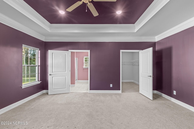 unfurnished bedroom featuring ornamental molding, ceiling fan, and light colored carpet