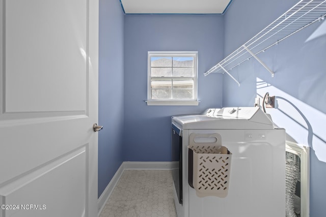 washroom with washing machine and dryer and light tile patterned floors