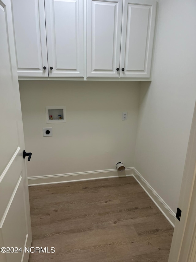 washroom featuring light wood-type flooring, cabinets, washer hookup, and electric dryer hookup