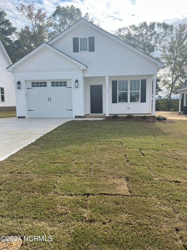 view of front of property with a front yard and a garage