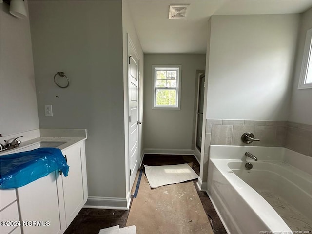 bathroom with vanity and plus walk in shower