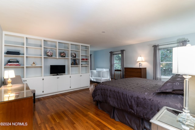 bedroom featuring dark wood-type flooring and multiple windows