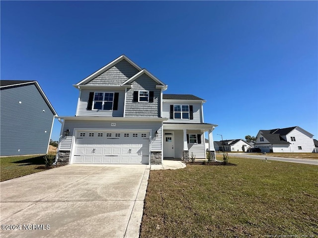 view of front of property with a garage and a front lawn