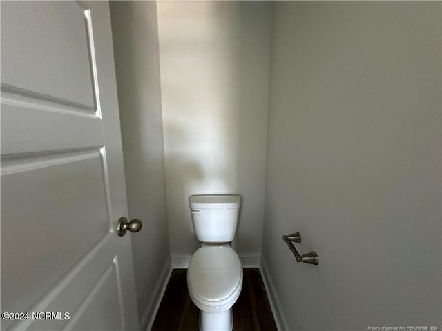 bathroom with hardwood / wood-style floors and toilet