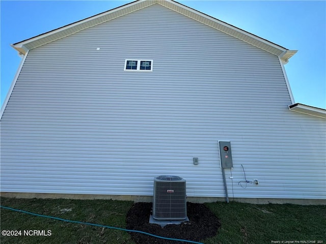 view of side of property with cooling unit