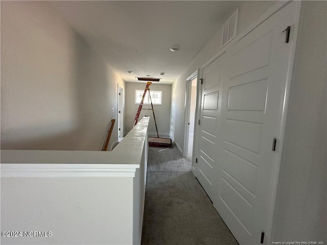 corridor with dark colored carpet