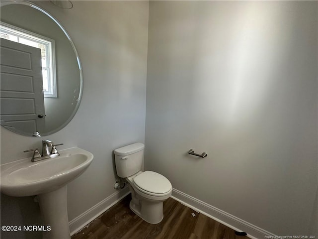 bathroom with toilet and wood-type flooring