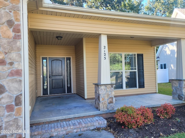 doorway to property featuring a porch