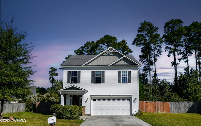 view of front facade featuring a garage and a lawn