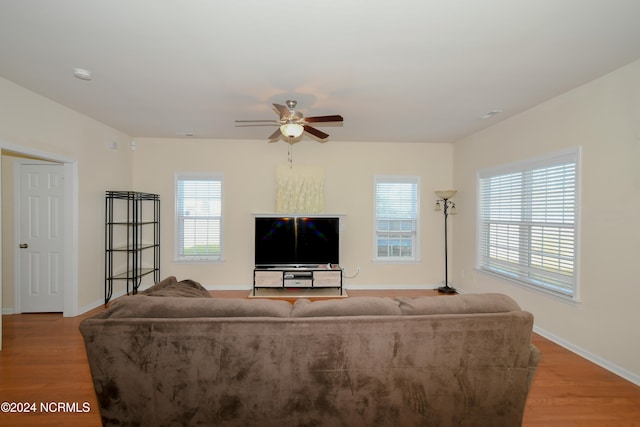 living room featuring light hardwood / wood-style floors and ceiling fan