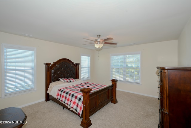 bedroom featuring light carpet and ceiling fan