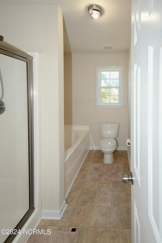 bathroom featuring toilet, independent shower and bath, and tile patterned flooring