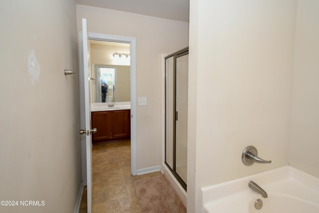 bathroom with vanity and separate shower and tub