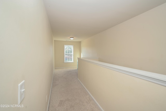 hallway with light colored carpet