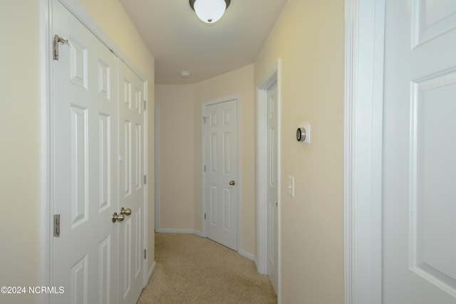 hallway with light colored carpet