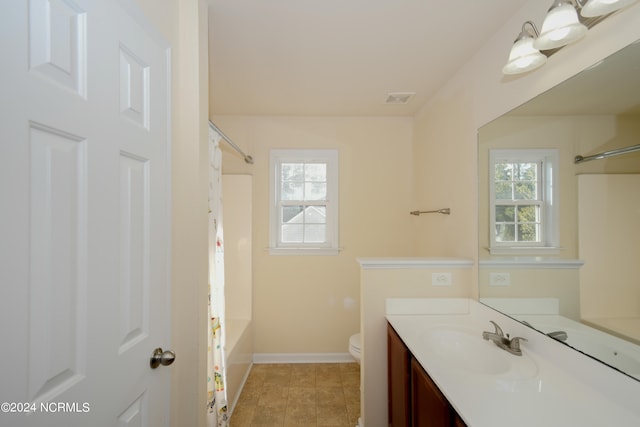 full bathroom with vanity, shower / bath combination with curtain, toilet, and plenty of natural light