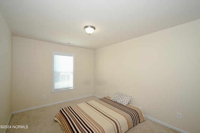 bedroom with light carpet