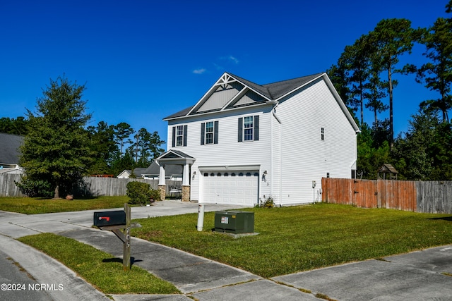 view of front of home featuring a front yard and a garage