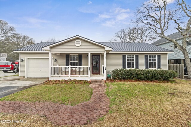 ranch-style home featuring a porch, a front lawn, and a garage