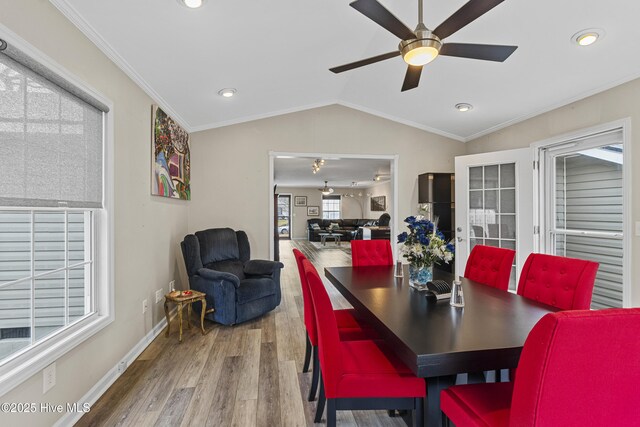 kitchen featuring wall chimney range hood, sink, backsplash, electric range, and light hardwood / wood-style flooring