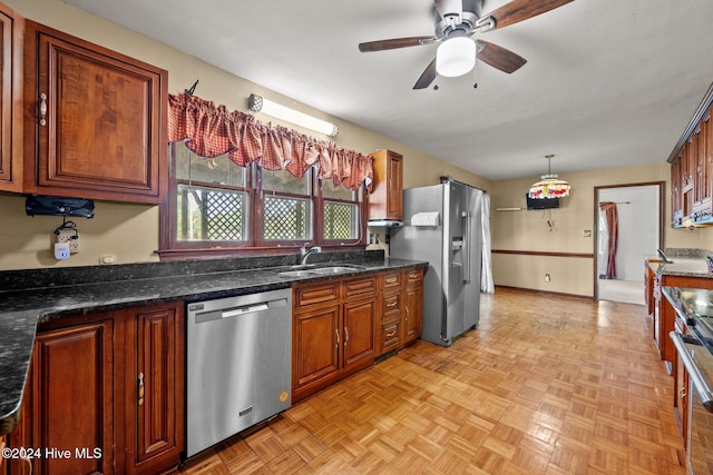 kitchen featuring light parquet floors, appliances with stainless steel finishes, hanging light fixtures, sink, and ceiling fan